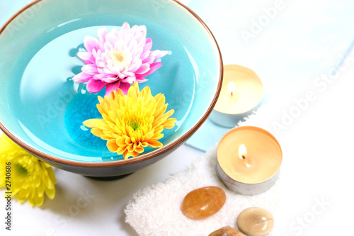 bowl of floral water and candles for spa