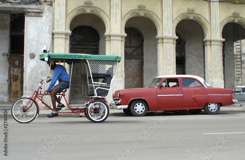 Photography bike taxi and red taxi in cuba