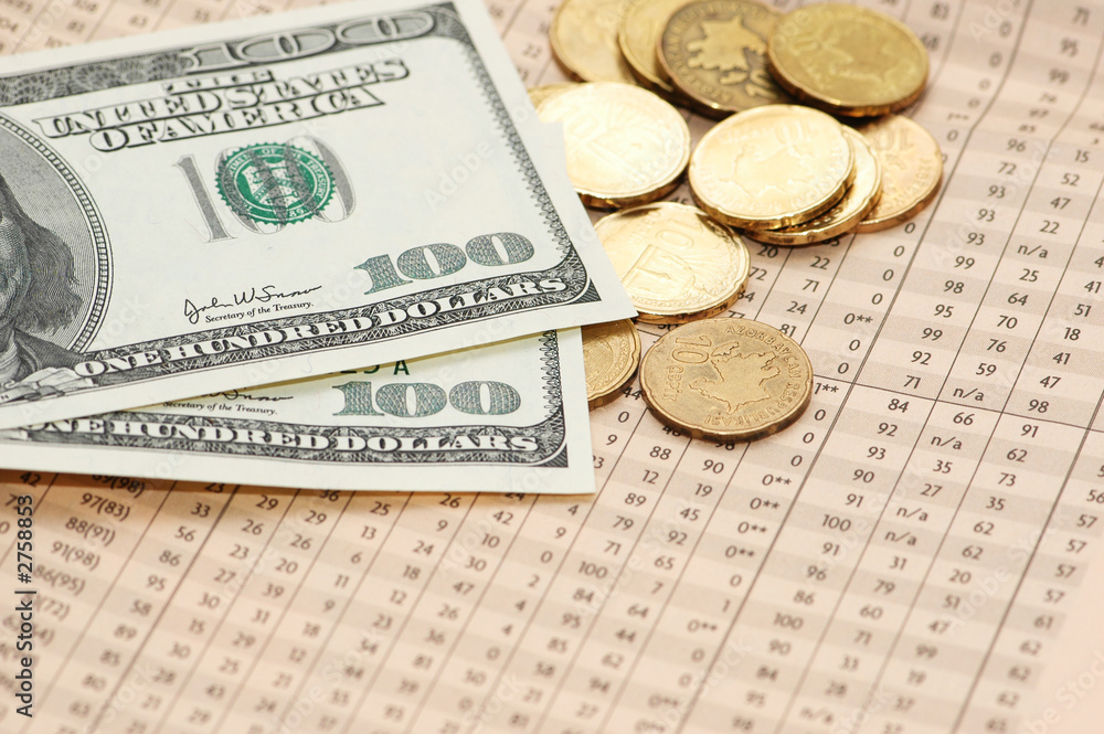 hundred dollar bank notes and coins over financial hundred dollar bank notes and coins over financial