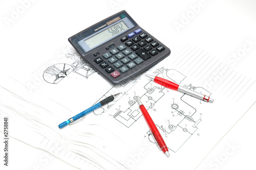 pens and calculator over the engineering drawings