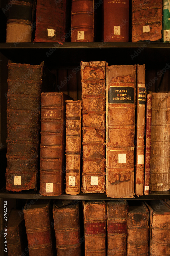 portrait image of books on a shelf portrait image of books on a shelf