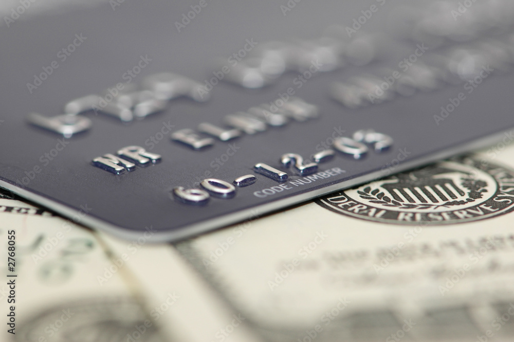 credit card and dollars with shallow depth of fiel credit card and dollars with shallow depth of fiel