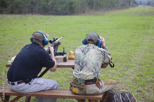 shooting from a bench outdoors at long distance with a spotter watching where each shot lands