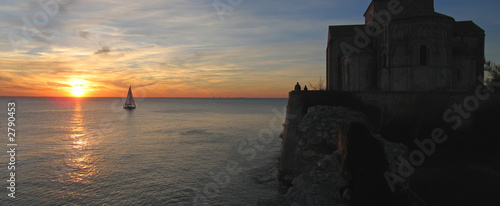 sunset at the talmont church with a sailing boat, france, panora photo