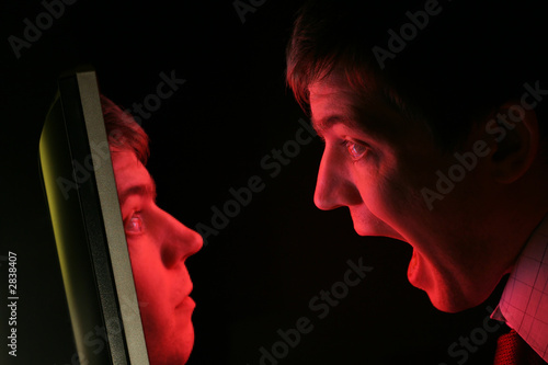 man screaming at own pixelated face