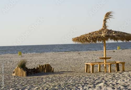 reed umbrela on the beach photo