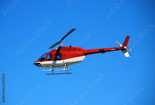 red helicopter in flight bell 206