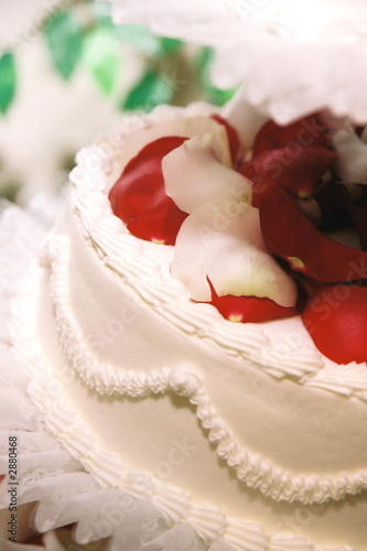close up of red roses on wedding cake