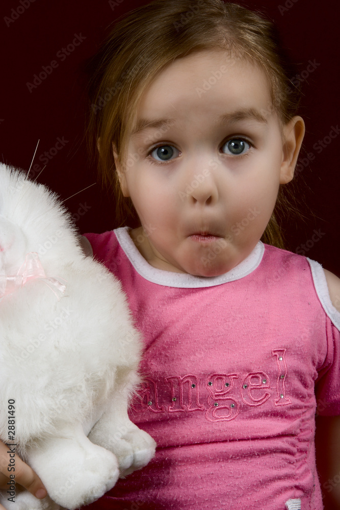 the small surprised girl with a toy