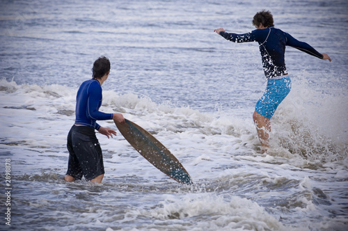 skim boarders in the waves