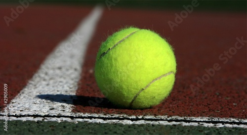 tennis ball in the corner of a tennis field