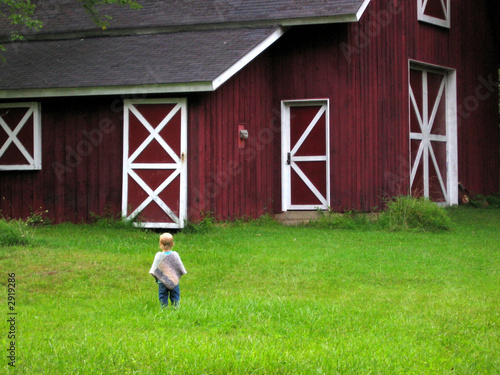 little girl looking at barn