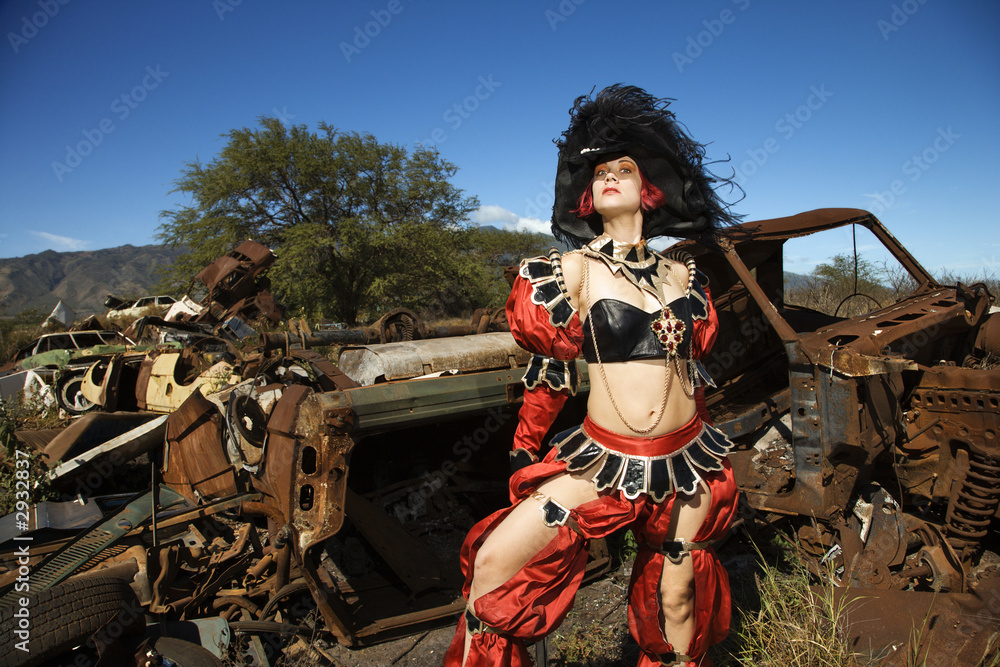 woman dressed as pirate in junkyard.