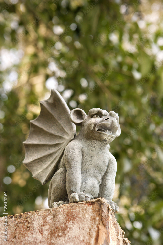 low angle of stone gargoyle statue outdoors.