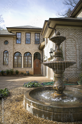 outdoor front view of home with fountain.