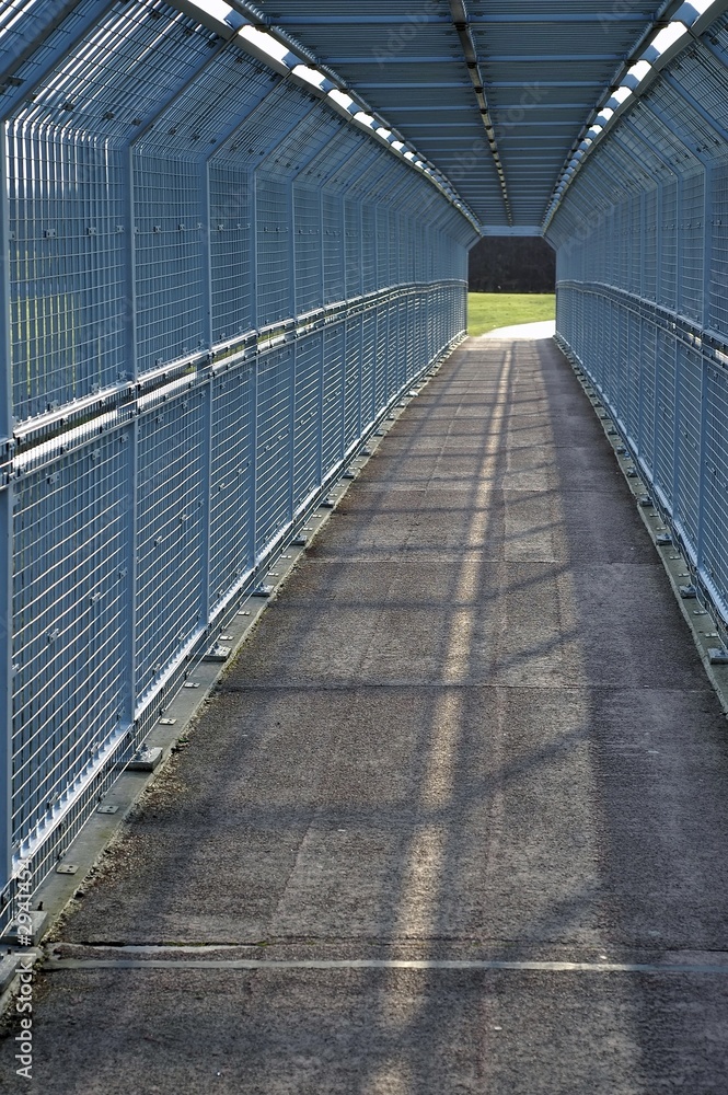 narrow path surrounded with iron fencing narrow path surrounded with iron fencing