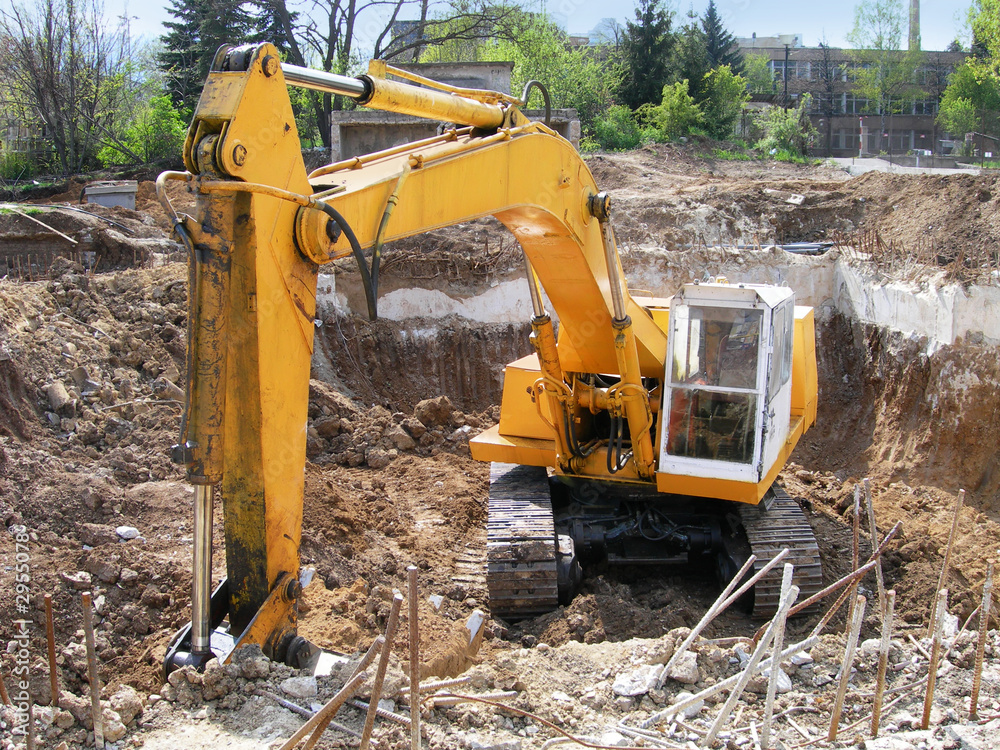 Fototapeta premium yellow excavator digging