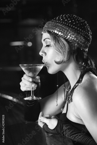 Quadro su tela retro female sitting at bar drinking martini.