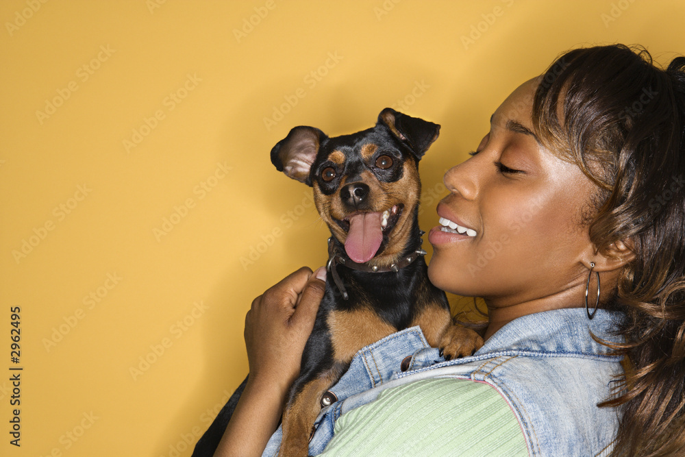 Obraz premium Woman holding small dog.