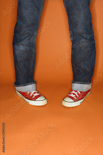 person in jeans and sneakers