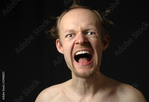  crazy angry man shouting on black background