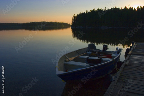 Calm waters at sunrise at a lake in Canada begging fishermen to get out for the early fishing bite