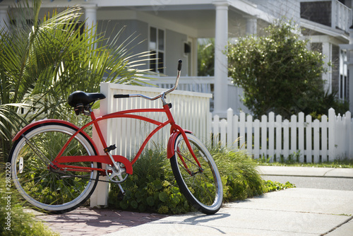 Red bicycle in front of house. photo