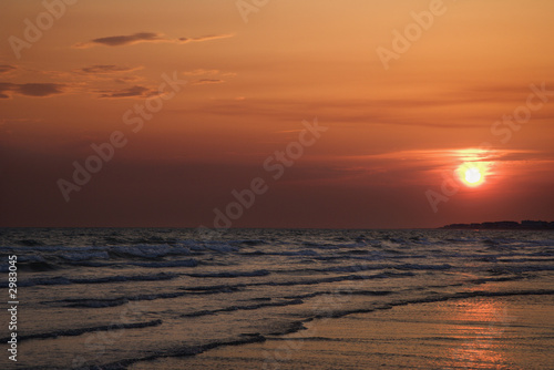 Sun setting over beach on Bald Head Island, North Carolina.
