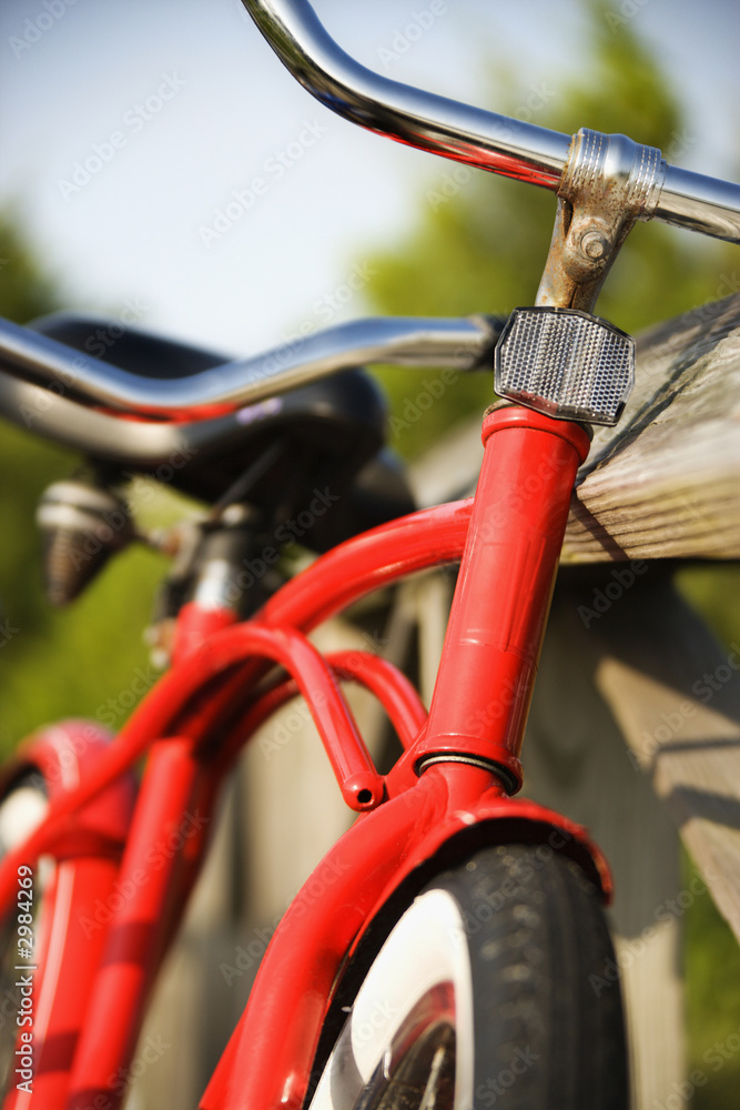 Red bike leaning against railing. Red bike leaning against railing.