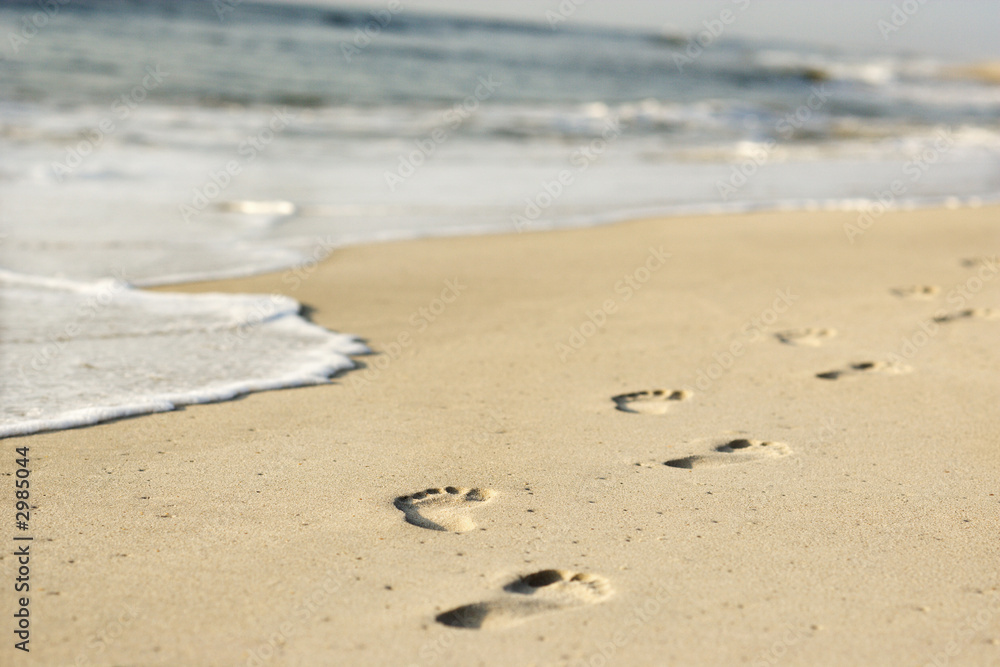 Coastline with footprints and waves. Coastline with footprints and waves.