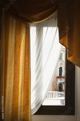 Window with drapes in Venice  Italy.