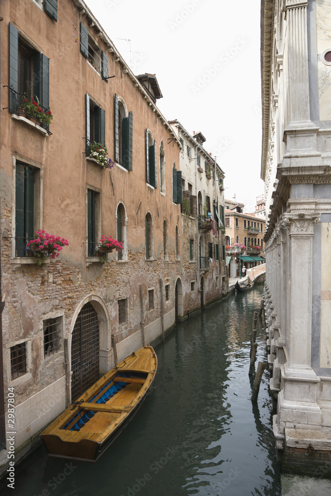 Naklejka premium Canal with boat and buildings in Venice, Italy.