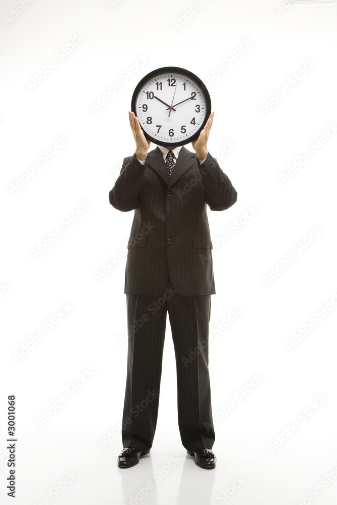 businessman holding clock. businessman holding clock.