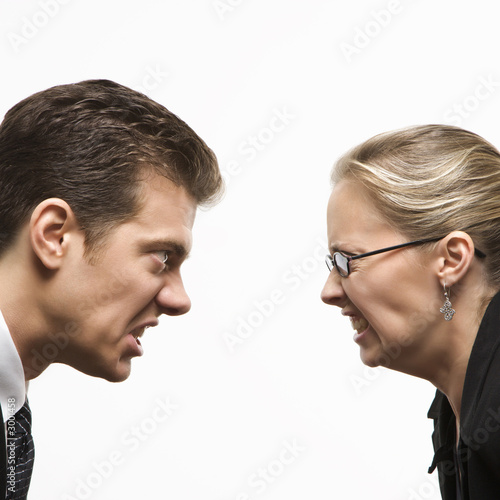 man and woman staring at each other with hostile expressions.