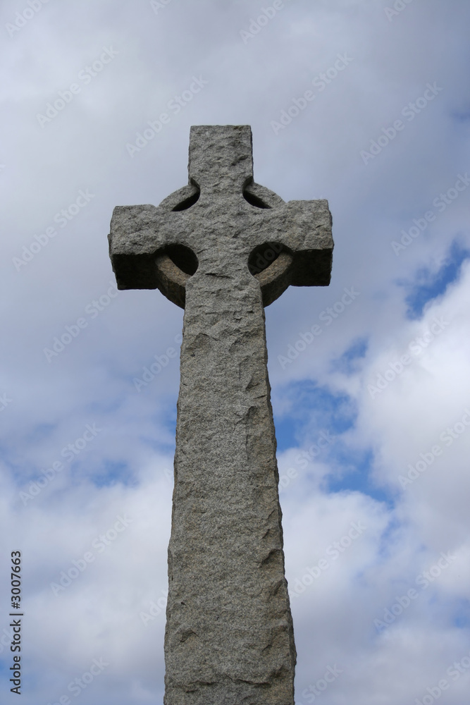 stone celtic cross against sky