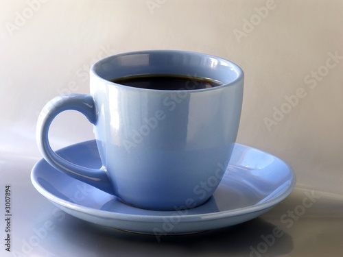 a blue cup of strong black coffee
