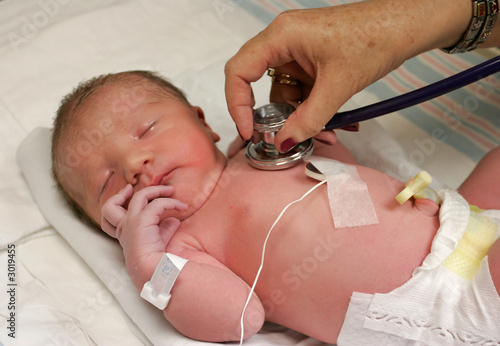 newborn being checked by doctor