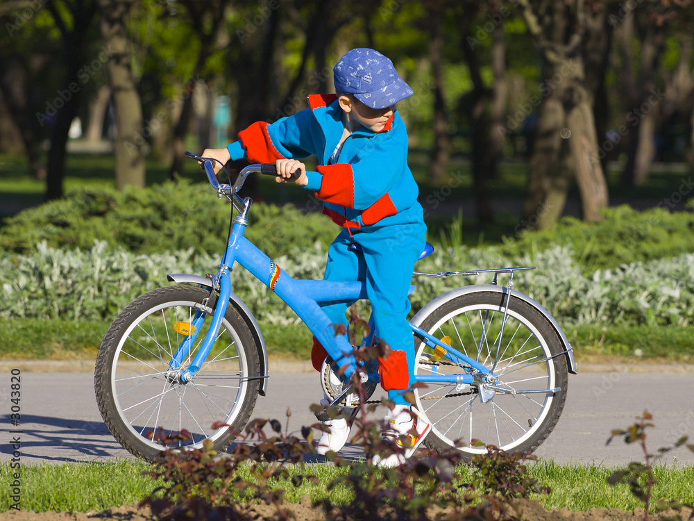 Naklejka premium little boy on his bicycle