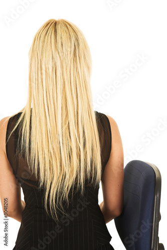 blonde businesswoman in black on office chair