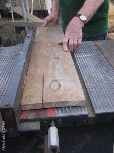 man sawing a piece of wood