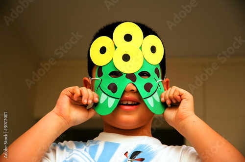 boy fooling around with a mask