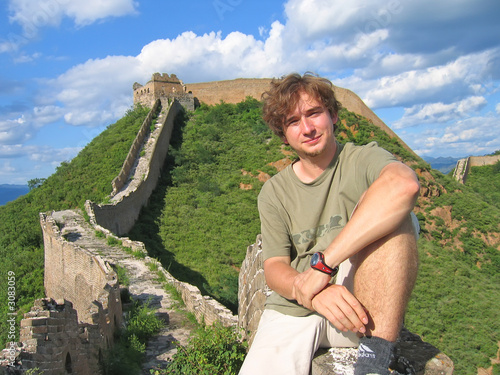 a trekker man having some rest on the great wall of china, china photo