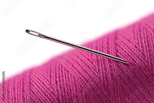 needle and a pink thread-closeup