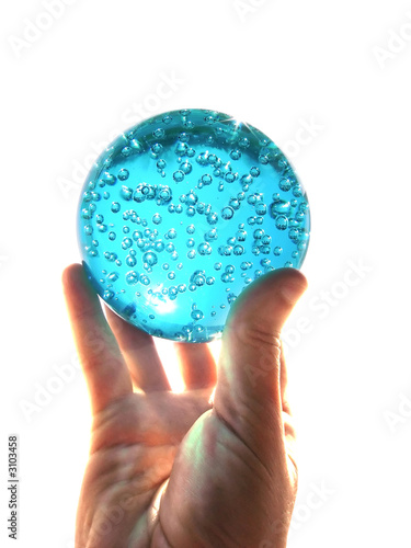 hand holding a glass ball