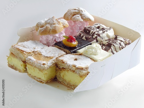 paper box with many tasty cakes photo