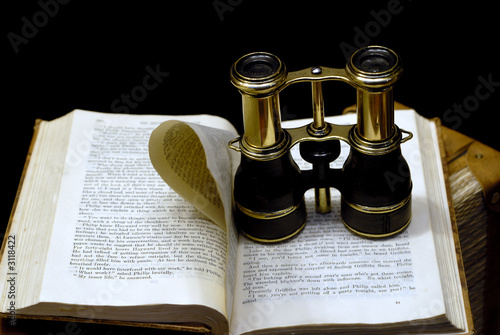 binoculars on book