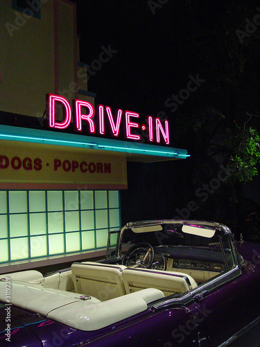 retro drive-in and convertible at night