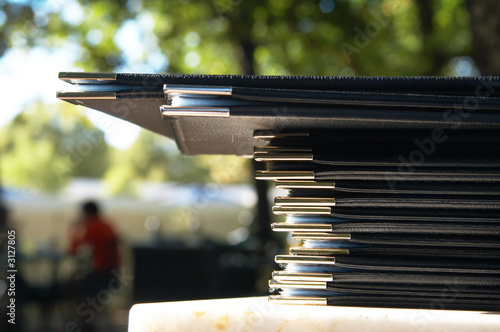 stack of menus on marble surface