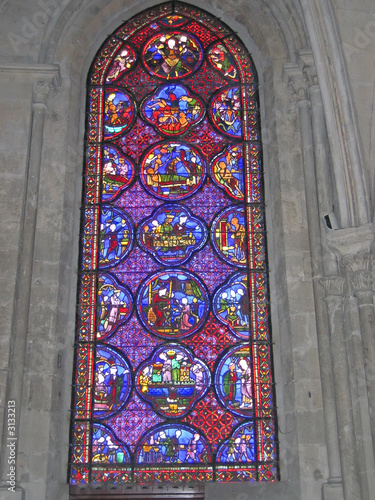 a blue and red stained glass window in the choir of the cathedra photo