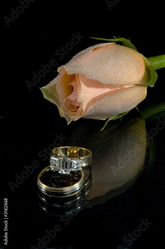 wedding rings and rose reflecting